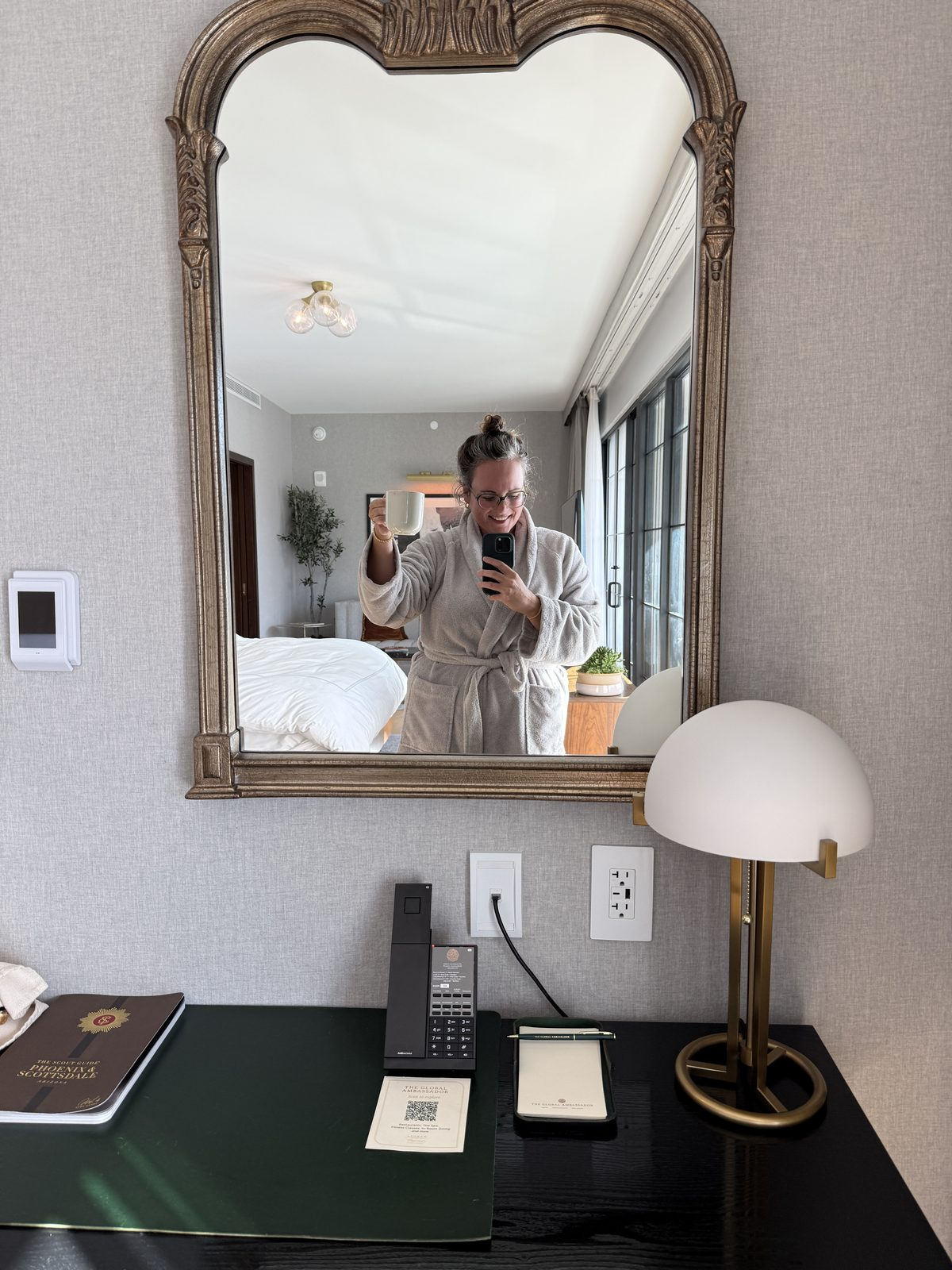 Nichole of Alpha Celiac Gal in a hotel robe with morning coffee in a Terrace Suite at The Global Ambassador