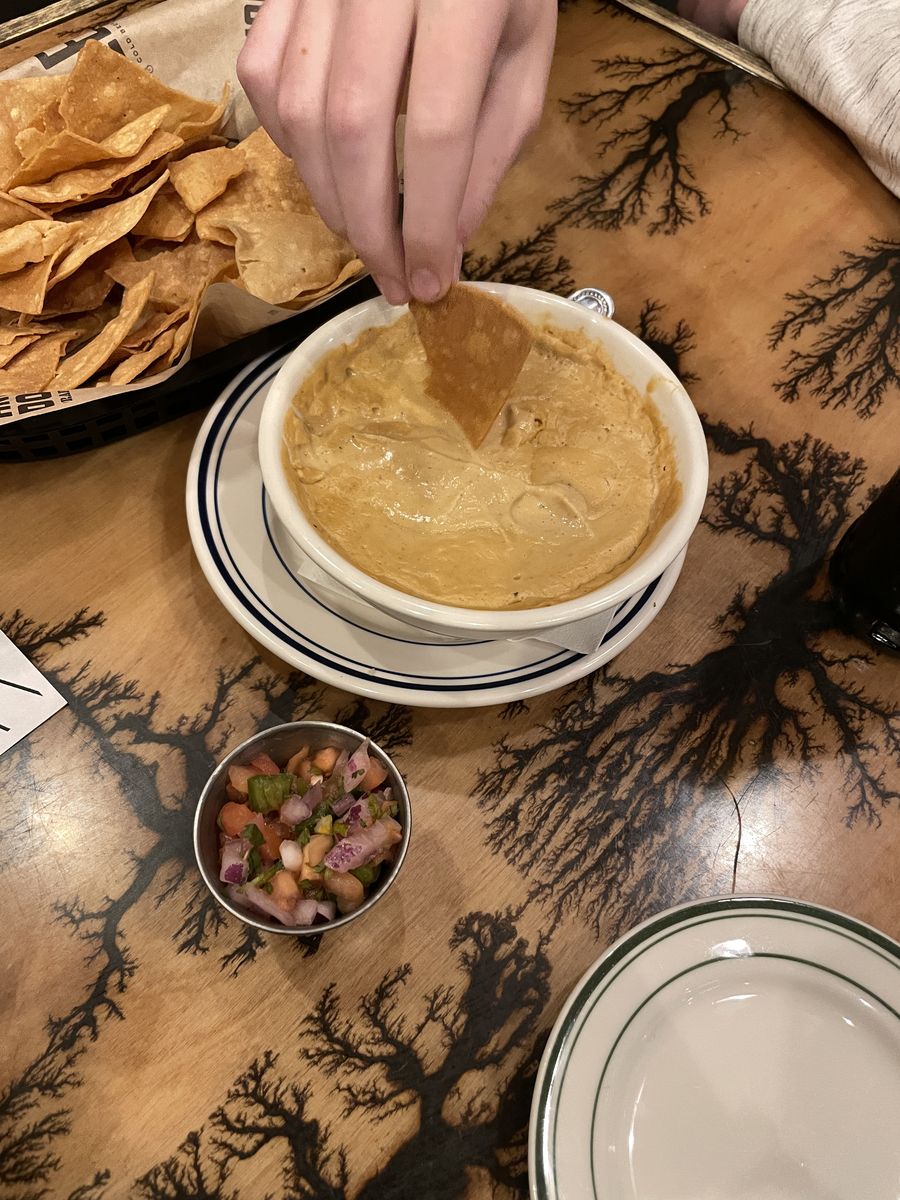 A bowl of vegan queso with tortilla chips and pico de gallo at The Press in Oklahoma City.